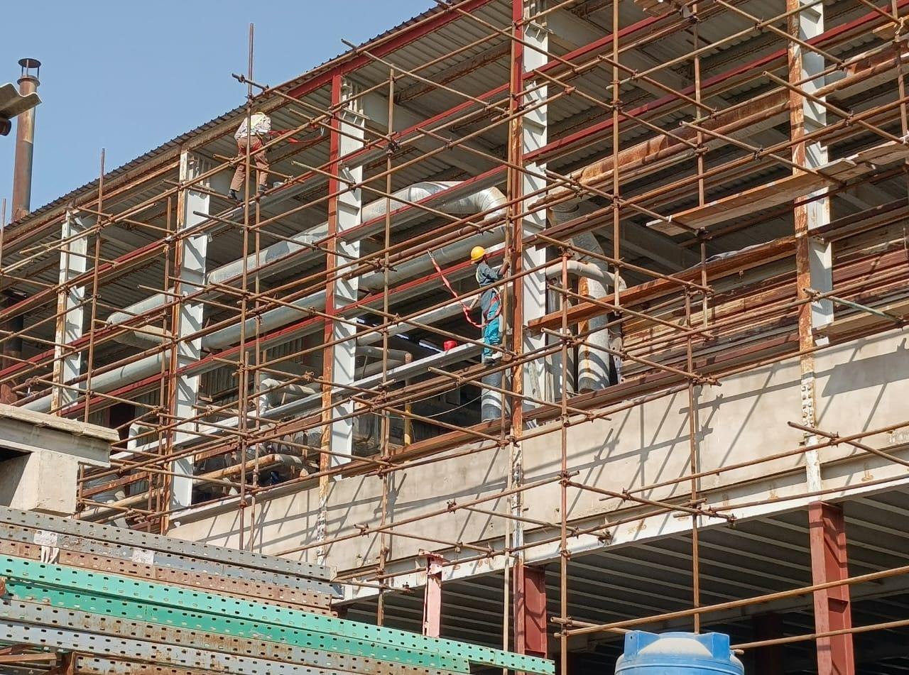 Scaffolding and piping work at an industrial plant maintenance site