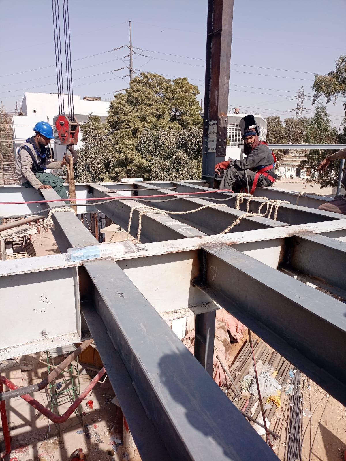 Structural steel erection team working on an industrial building frame